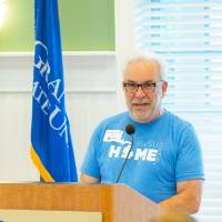 An alumnus speaks before Move-In